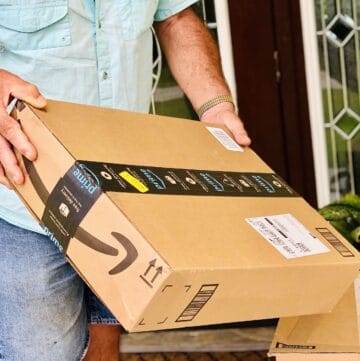 shopping-online-homeowner-picking-up-his-package-delivery-that-we-re-delivered-by-amazon-nominated_t20_YNaPJm