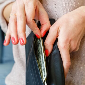 woman taking cash out of wallet