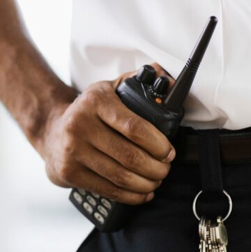 security guard with hand on walkie-talkie - Home Depot's Shoplifting Policy