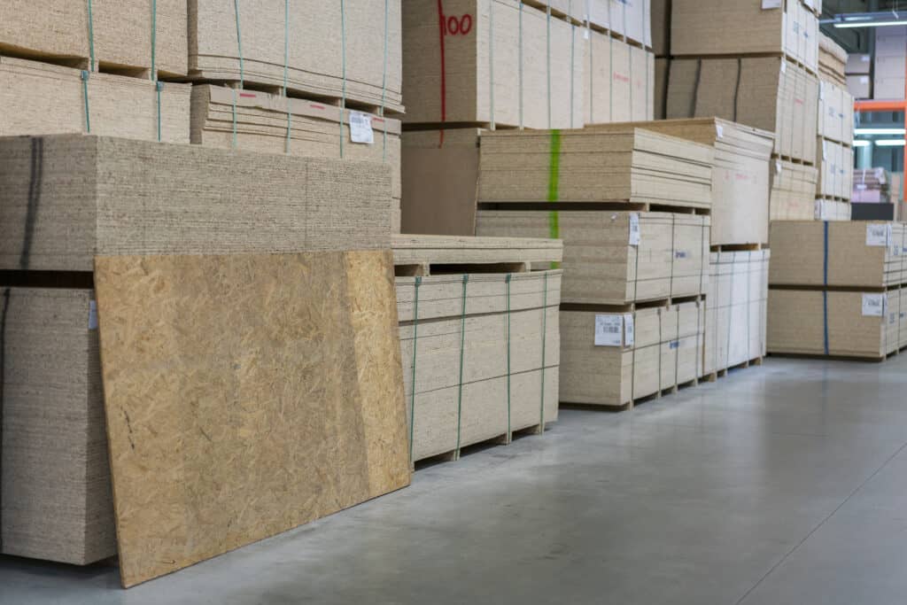 Does Home Depot Deliver Drywall - Sawn timber. Drywall, dvp, chipboard, Shelf with structural materials on the shelves in the construction warehouse. Delivery concept.